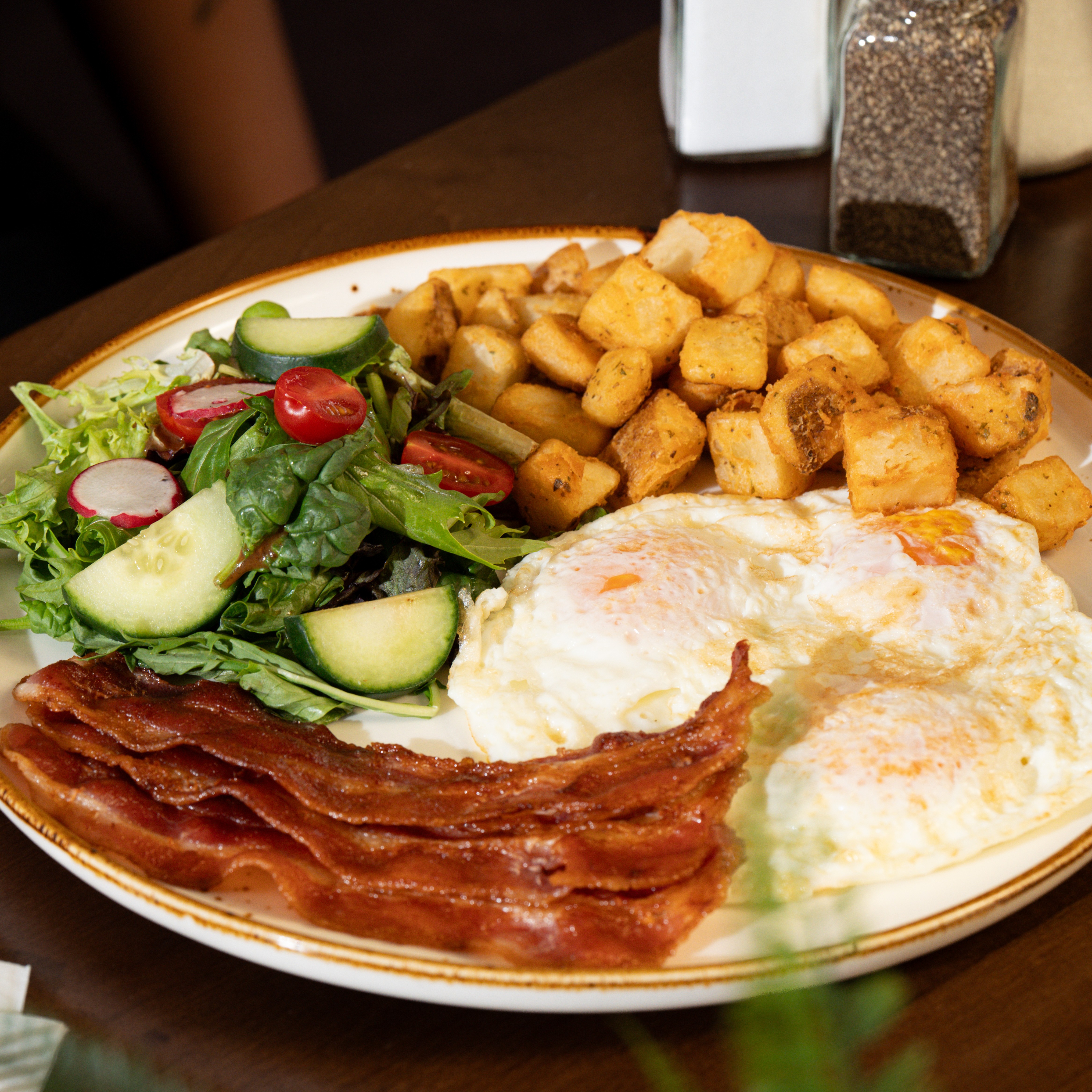 Solena Sunrise Breakfast — Three eggs cooked your way with your choice of breakfast meat, herbed home fries, house salad, and choice of toast. — Brunch Favourites at SOLENA Brunch & Bar in Corso Italia, Toronto