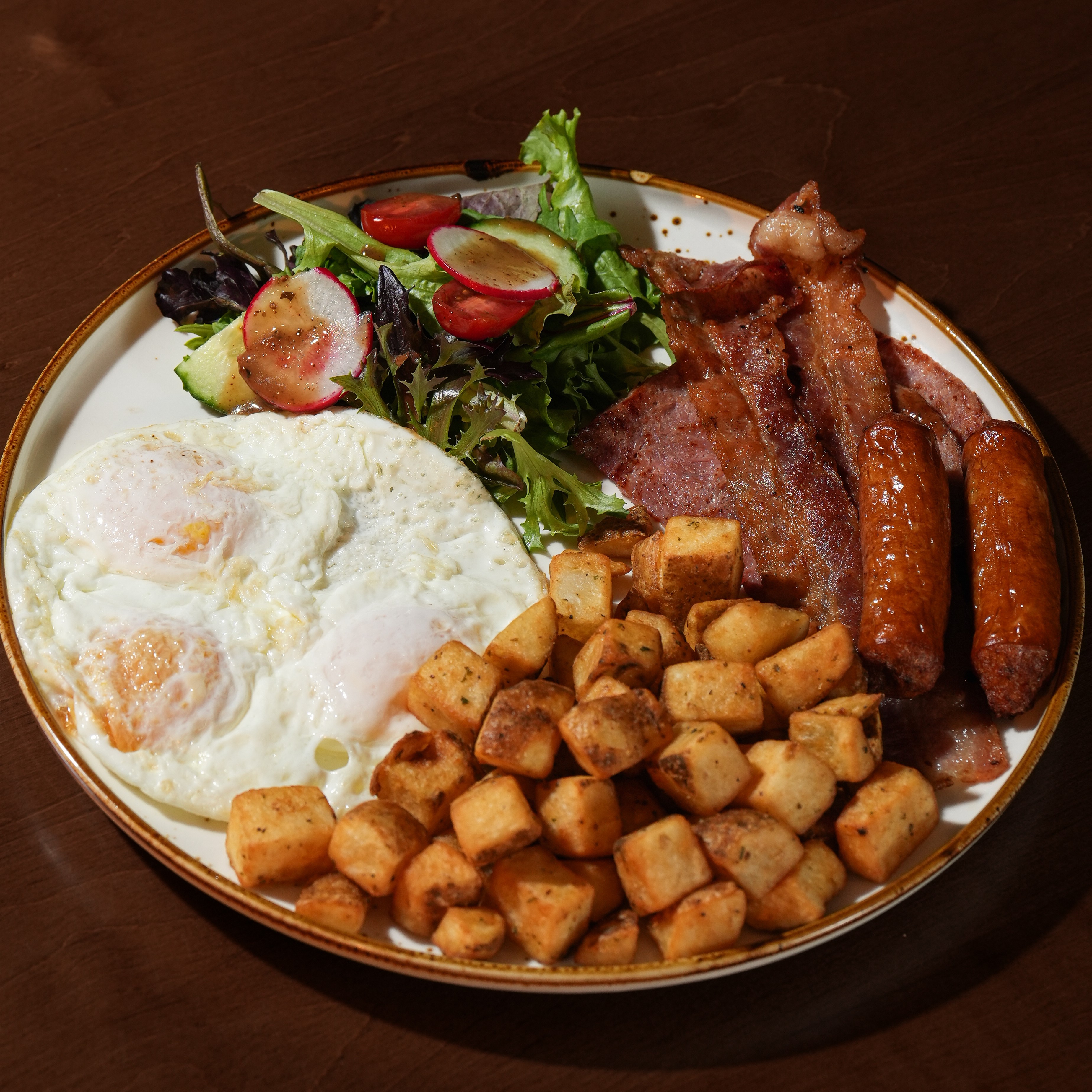 Ultimate All in one Breakfast — Three eggs cooked your way with bacon, sausage, Black Forest ham, herbed home fries, house salad, and toast. — Brunch Favourites at SOLENA Brunch & Bar in Corso Italia, Toronto
