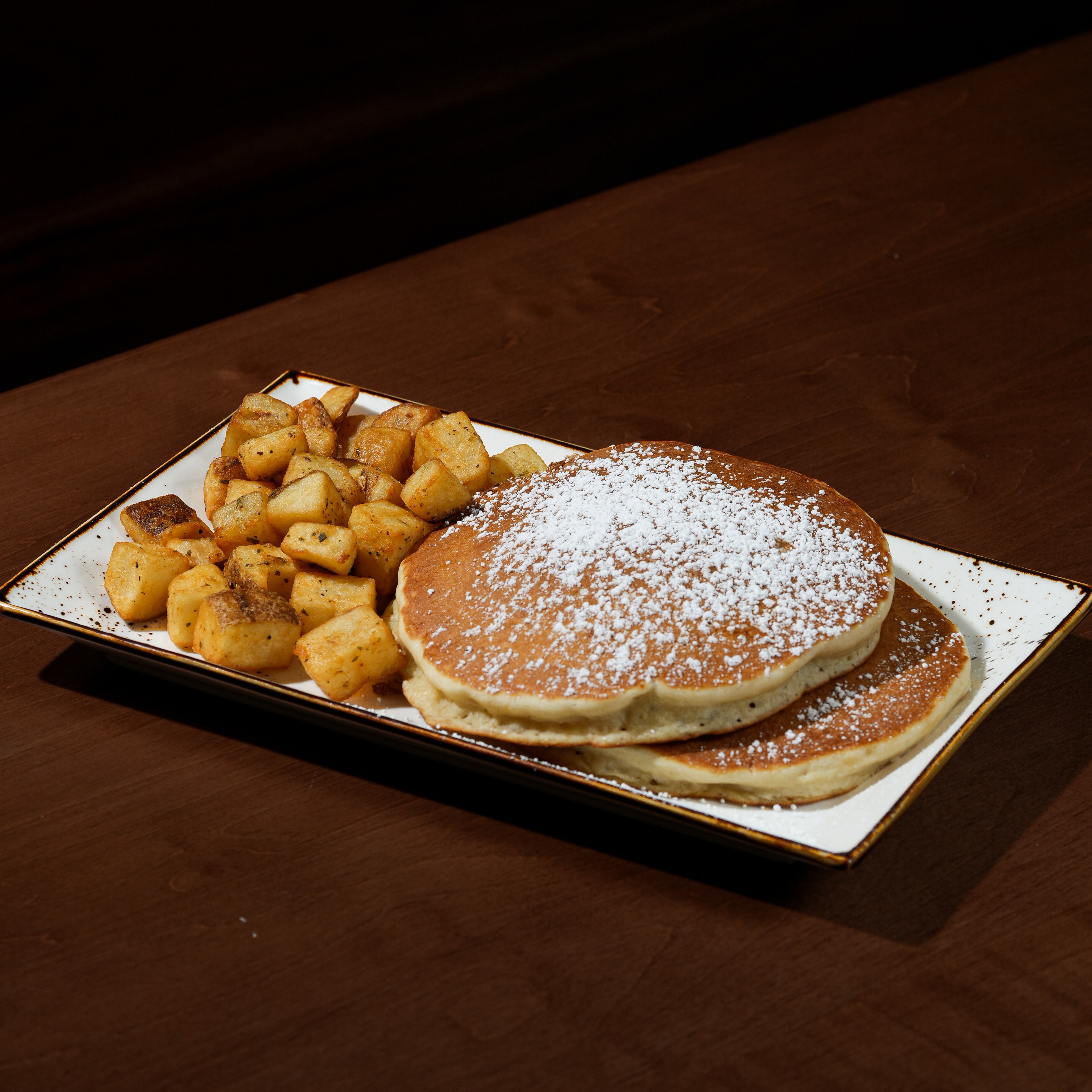 Button Pancakes — Two mini chocolate chip pancakes with home fries. — Little Brunchers at SOLENA Brunch & Bar in Corso Italia, Toronto