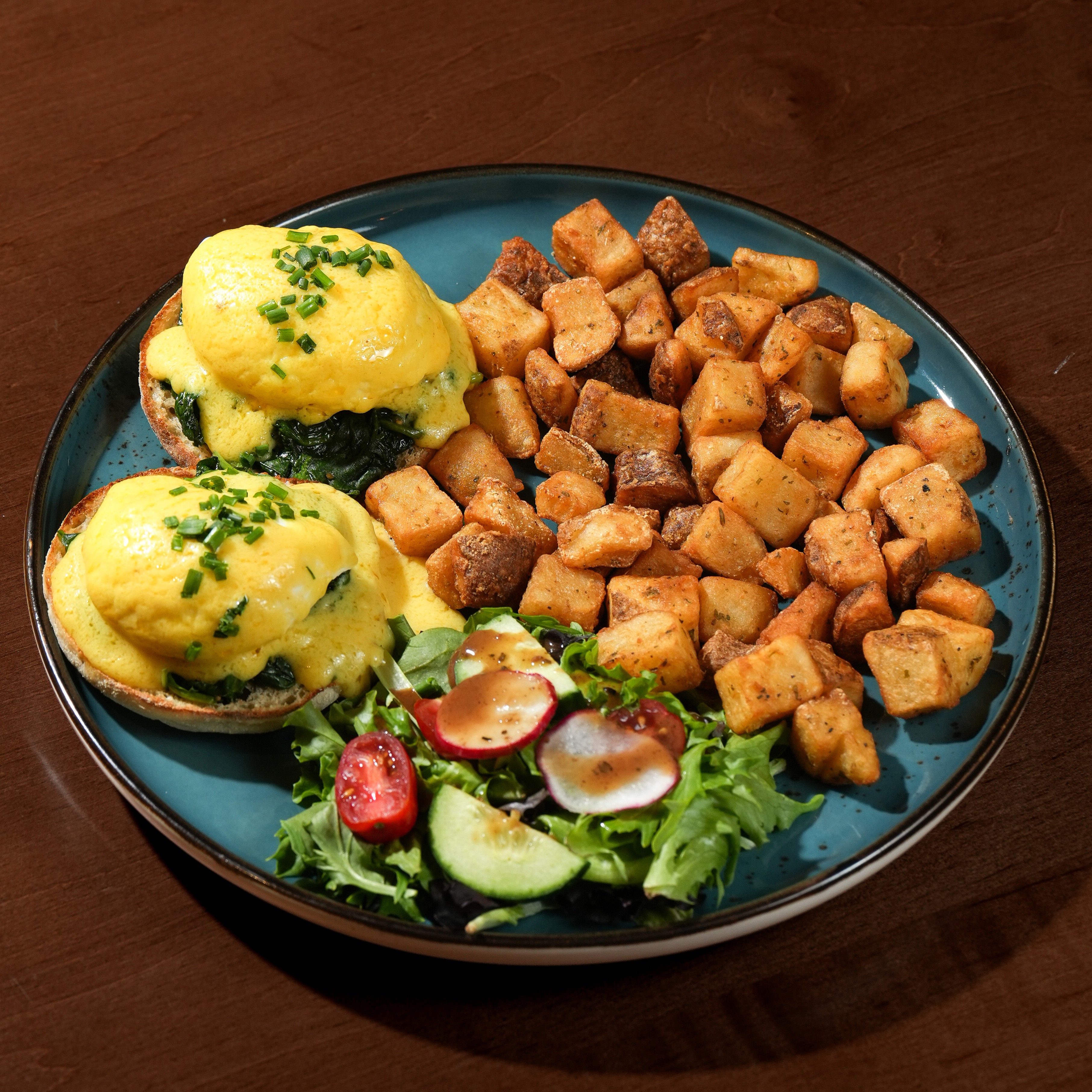 Florentine Benny — Sautéed spinach, two poached eggs and hollandaise on an English muffin with home fries and house salad. — Benedicts at SOLENA Brunch & Bar in Corso Italia, Toronto