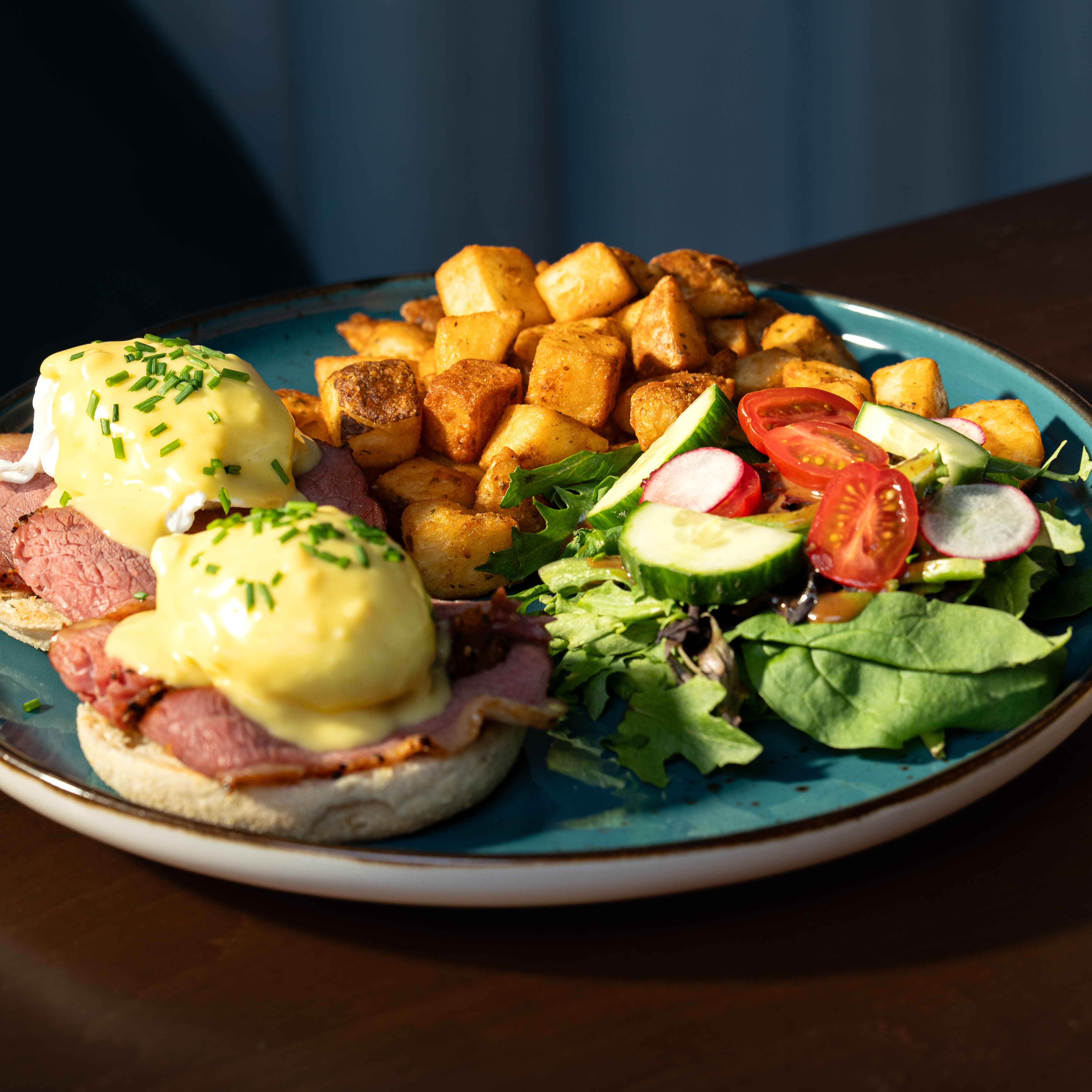Montreal Benny — Montreal smoked meat, two poached eggs and hollandaise on an English muffin with home fries and house salad.