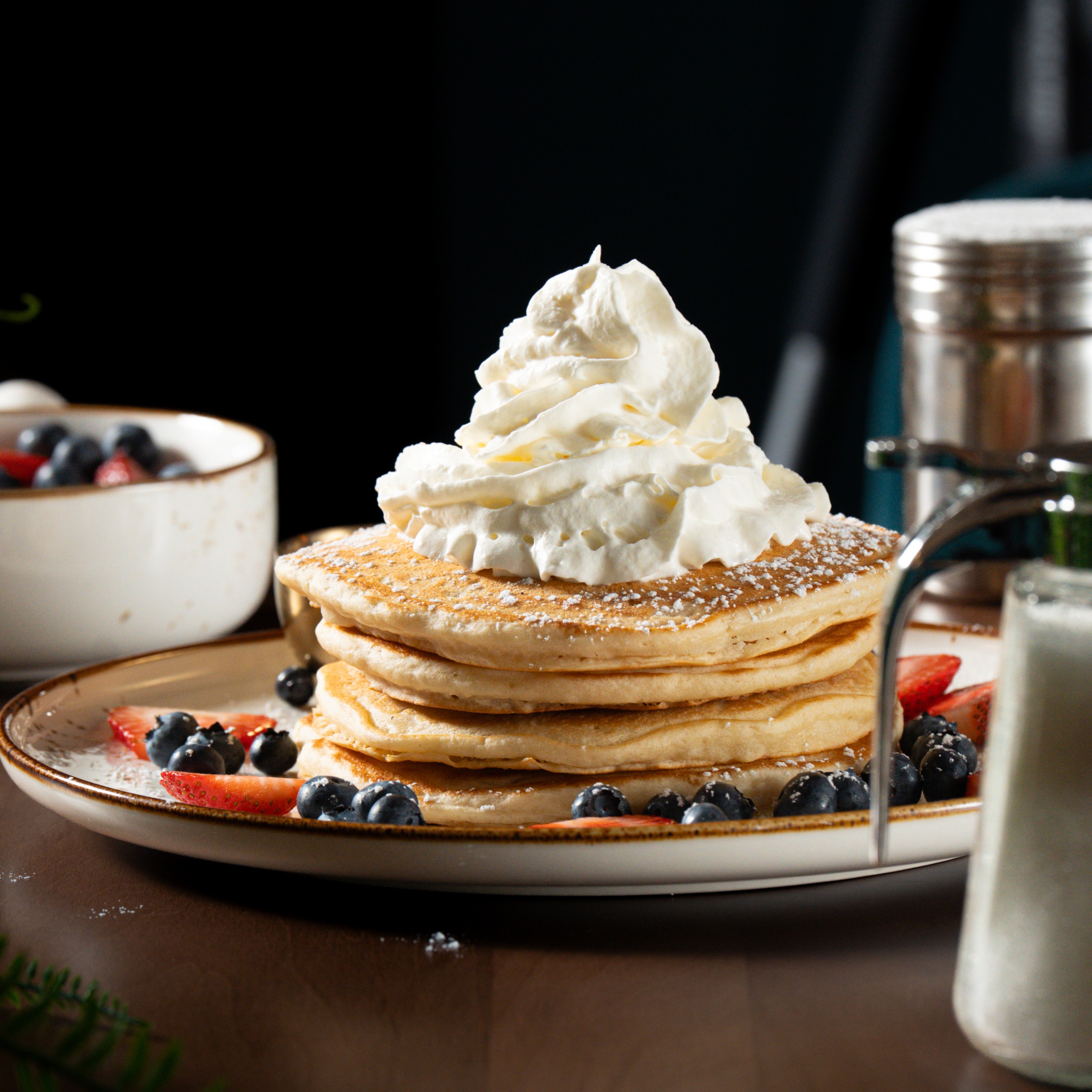Classic Buttermilk Pancakes — Four fluffy pancakes, fresh berries, whipped cream, and Canadian maple syrup. — Sweet Brunch at SOLENA Brunch & Bar in Corso Italia, Toronto